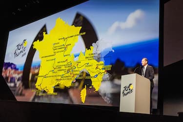 epa10938012 Tour de France General Director Christian Prudhomme speaks as he unveils the map of the stages during the presentation of the Men and Women Tour de France 2024 cycling race in Paris, France, 25 October 2023. The 111th edition of the Tour de France will start from Florence, Italy, on 29 June 2024 and will arrive in Nice, France, on 23 July 2024.  EPA/CHRISTOPHE PETIT TESSON
