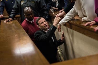 South African Paralympian athlete Oscar Pistorius holds the hand of a relative as he leaves Pretoria High Court, South Africa, on July 6, 2016. The High Court in Pretoria on Wednesday handed down a six-year sentence to Paralympian Oscar Pistorius for killing his girl friend Reeva Steenkamp.