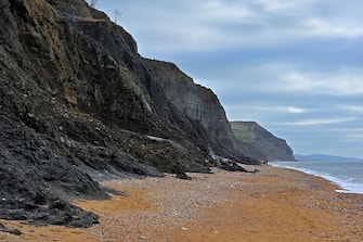 Black Ven landslide on beach between Lyme Regis and Charmouth along the Jurassic Coast, Dorset, southern England, UK. (Photo by: Arterra/Universal Images Group via Getty Images)