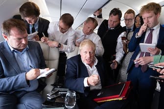 IN FLIGHT - JUNE 28: UK Prime Minister Boris Johnson talks to journalists during a flight from Germany where he was attending the G7 Summit, to the NATO Summit in Spain, on June 28, 2022. The two-day summit will align the alliance's defense posture along its eastern edge, including ramping up troop levels and positioning heavy equipment, as Western leaders contemplate the next phase of the war in Ukraine. (Photo by Stefan Rousseau - Pool/Getty Images)