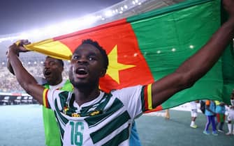 Cameroon's defender #18 Darlin Yongwa celebrates after his team won the Africa Cup of Nations (CAN) 2024 group C football match between Gambia and Cameroon at Stade de la Paix in Bouake on January 23, 2024. (Photo by Kenzo TRIBOUILLARD / AFP)