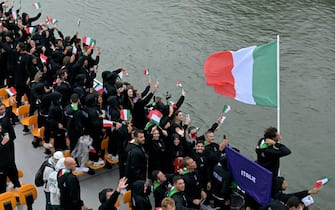 Italy's delegation with Italy's flag bearer Gianmarco Tamberi (R) sails on a boat during the opening ceremony of the Paris 2024 Olympic Games in Paris on July 26, 2024. (Photo by Damien MEYER / AFP) (Photo by DAMIEN MEYER/AFP via Getty Images)