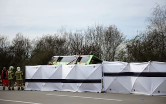 27 March 2024, Saxony, Schkeuditz: The coach is set up behind mobile safety barriers at the scene of the accident on the A9. At least five people have died in an accident involving a coach on the A9 near Leipzig. This was announced by the police on request. There were also numerous injuries in the accident on Wednesday. Photo: Jan Woitas/dpa (Photo by Jan Woitas/picture alliance via Getty Images)
