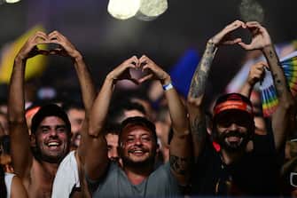 Fans hold up their hands in the shape of hearts as US pop star Madonna performs during a free concert at Copacabana beach in Rio de Janeiro, Brazil, on May 4, 2024.Â . Madonna ended her "The Celebration Tour" with a performance attended by some 1.5 million enthusiastic fans. (Photo by Pablo PORCIUNCULA / AFP) (Photo by PABLO PORCIUNCULA/AFP via Getty Images)