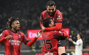 AC Milan’s forward Luka Jovic (Below) celebrates with teammates defender Theo Hernández and forward Samuel Chukwueze /(L) after scoring during the Coppa Italia (Italy Cup) soccer match between AC Milan and  Cagliari at the Giuseppe Meazza Stadium in Milan, Italy,  2 January 2024. ANSA/DANIEL DAL ZENNARO