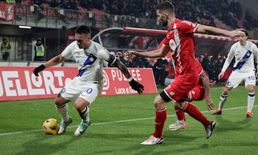FC Inter's forward Lautaro Martínez in action against AC Monza's mildfielder Roberto Gagliardini during the Italian Serie A soccer match between AC Monza and FC Inter at U-Power Stadium in Monza, Italy, 13 January 2024. ANSA / ROBERTO BREGANI