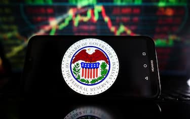 POLAND - 2023/03/20: In this photo illustration, a US Federal Reserve logo is displayed on a smartphone with stock market percentages on the background. (Photo Illustration by Omar Marques/SOPA Images/LightRocket via Getty Images)