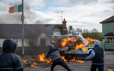 Members of the dissident republicans nationalist group throw petrol bombs at a police vehicle as they hold an anti-agreement rally on the 25th anniversary of the peace deal in Londonderry, also known as Derry, Northern Ireland, UK, on Monday, April 10, 2023. US President Joe Biden will visit Northern Ireland and the Republic of Ireland to coincide with the 25th anniversary of the signing of the Good Friday Agreement. Photographer: Chris J. Ratcliffe/Bloomberg