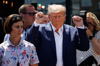 DES MOINES, IOWA - AUGUST 12: Former U.S. President Donald Trump acknowledges supporters as the visits the Iowa State Fair on August 12, 2023 in Des Moines, Iowa. Republican and Democratic presidential hopefuls are visiting the fair, a tradition in one of the first states that will test candidates with the 2024 caucuses. (Photo by Chip Somodevilla/Getty Images)