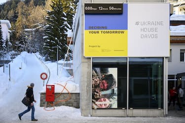 epaselect epa11074026 A person walks near the 'Ukraine House Davos' in Promenade street ahead of the 54th annual meeting of the World Economic Forum (WEF) in Davos, Switzerland, Saturday, January 13, 2024. Switzerland, 13 January 2024. The meeting brings together entrepreneurs, scientists, corporate and political leaders in Davos under the topic 'Rebuilding Trust' from 15 to 19 January.  EPA/LAURENT GILLIERON