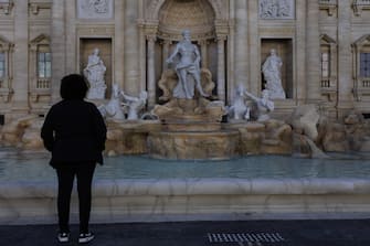 epa10634885 A tourist looks on the replica of the iconic Fontana di Trevi, built to honor Italian immigrants and boost tourism, in the city of Serra Negra, Brazil, 17 May 2023. The Serra Negra Fountain occupies an area of 370 square meters and is 11 meters high, from the water mirror, and 20.7 meters wide.  EPA/ISAAC FONTANA