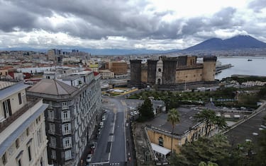 View of the empty street in Naples city, on backgound the Maschio Angioino Castle and Vesuvius, after the Italian government has imposed unprecedented national restrictions on controlling the coronavirus COVID-19.