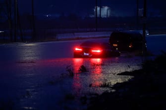 epa10811188 A car is half submerged in water on the side of a road in Santa Clarita, California, USA, 20 August 2023. Southern California is under a tropical storm warning for the first time in history as Hilary makes landfall. The last time a tropical storm made landfall in Southern California was 15 September 1939, according to the National Weather Service.  EPA/CAROLINE BREHMAN