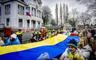 epa10488063 Protesters outside the Russian embassy in The Hague, Netherlands, staging a peace march on the first anniversary of the Russian invasion of Ukraine, 24 February 2023. Russian troops entered Ukrainian territory on 24 February 2022, starting a conflict that has provoked destruction and a humanitarian crisis. One year on, fighting continues in many parts of the country.  EPA/ROBIN UTRECHT