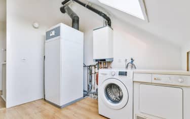Room with household appliances under a bright window