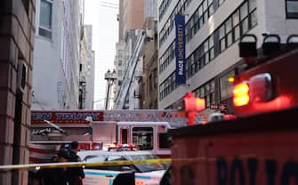 epa10579302 New York City Fire Department firefighters work on ladder trucks at the scene of a parking structure collapse in the Financial District of New York City, New York, USA, 18 April 2023. Fire Department officials have reported three injuries but advised they expect that to increase.  EPA/JUSTIN LANE