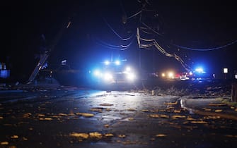 epa10402476 Police vehicles block a roadway among downed power lines following an outbreak across multiple states in Griffin, Georgia, USA, 12 January 2023.  EPA/ERIK S. LESSER