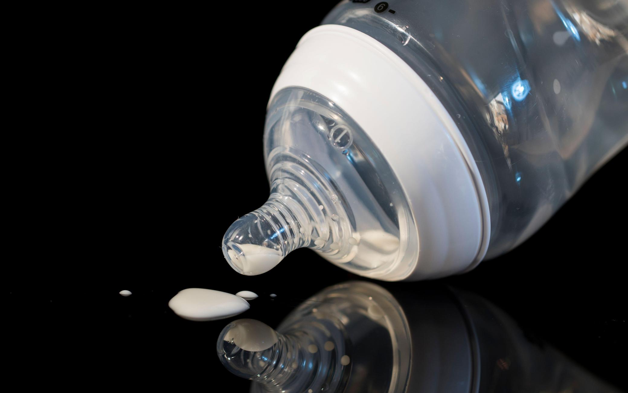 Nipple of bottle for baby food close up. Empty bottle of baby formula close up.