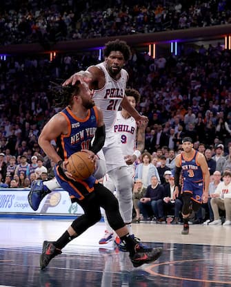 NEW YORK, NEW YORK - APRIL 30: Joel Embiid #21 of the Philadelphia 76ers fouls Jalen Brunson #11 of the New York Knicks at Madison Square Garden on April 30, 2024 in New York City. The Philadelphia 76ers defeated the New York Knicks 112-106 in overtime. NOTE TO USER: User expressly acknowledges and agrees that, by downloading and or using this photograph, User is consenting to the terms and conditions of the Getty Images License Agreement. (Photo by Elsa/Getty Images)