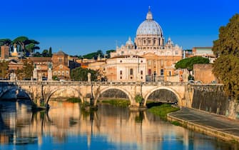 Rome, Italy. Vatican dome of San Pietro and Sant Angelo Bridge, over Tiber river.