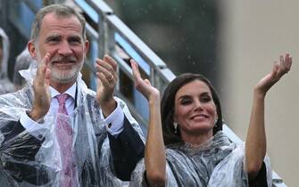 King of Spain Felipe VI (L) and Queen of Spain Letizia (R) applaud the announcement of the Spanish athletes during the opening ceremony of the Paris 2024 Olympic Games in Paris on July 26, 2024. (Photo by Oli SCARFF / AFP)