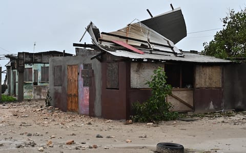 epa12486750 A house stands damaged by the preliminary winds of Hurricane Melissa at Hellshire Fishing Beach in Portmore, Jamaica, 27 October 2025. Jamaican Prime Minister Andrew Holness said the government has a multifaceted plan to ensure a 'swift and effective' response to the storm