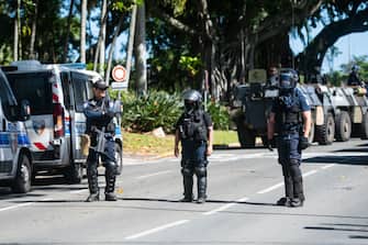 Police in riot gear are seen outside a police station in Noumea, France's Pacific territory of New Caledonia, on May 18, 2024. Hundreds of French security personnel tried to restore order in the Pacific island territory of New Caledonia on May 18, after a fifth night of riots, looting and unrest. (Photo by Delphine Mayeur / AFP) (Photo by DELPHINE MAYEUR/AFP via Getty Images)
