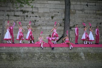 PARIS, FRANCE - JULY 26: Dancers performing French Cancan choreography as part of one of twelve artistic tableaux, are pictured from the boat of Brazil's delegation  sailing along the river Seine during the opening ceremony of the Olympic Games Paris 2024 on July 26, 2024 in Paris, France. (Photo by Carl de Souza-Pool/Getty Images)