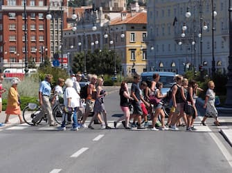 People are crossing the roads on crosswalk.