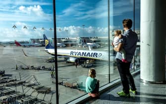 Waiting family at airport, man and kids watch planes on runway Airport Palma de Mallorca