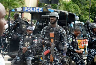 Policemen mount guard as members of Nigeria Labour Congress (NLC) and Trade Union Congress (TUC) and Civil Society Group stage a protest over the hardship facing the mass as a result of the removal of fuel subsidy by the government, in Ikeja, Lagos, Nigeria on Wednesday, August 2, 2023. (Photo by Adekunle Ajayi/NurPhoto via Getty Images)