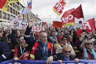 epa10538304 People attend a rally against the government's reform to the pension system, in Marseille, France, 23 March 2023. Protests continue in France after the prime minister announced on 16 March 2023 the use of Article 49 paragraph 3 (49.3) of the French Constitution to have the text on the controversial pension reform law - raising retirement age from 62 to 64 - be definitively adopted without a vote.  EPA/GUILLAUME HORCAJUELO