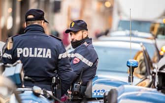 Milan, Italy  - December 22, 2014: Policemen on Via Monte Napoleone, Milan