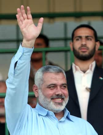 epa11510669 (FILE) - Hamas deposed Palestinian Prime Minister Ismail Haniyeh (L) waves towards Palestinian children taking part in a march on the sidelines of a summer camp organized by the Hamas at the Palestine stadium in Gaza City, 27 July 2009 (reissued 31 July 2024). According to the Islamic Republic News Agency, Hamas political chief Ismail Haniyeh and one of his bodyguards were killed in Tehran, Iran while in the country to attend the inauguration of Iran's newly elected president Masoud Pezeshkian.  EPA/ALI ALI