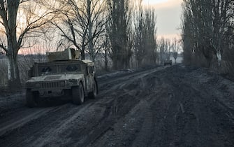 AVDIIVKA DISTRIKT, UKRAINE - FEBRUARY 14: Vehicles on the mud road to the city, the outskirts of Avdiivka on February 14, 2024 in Avdiivka district, Ukraine. Both Ukraine and Russia have recently claimed gains in the Avdiivka, where Russia is continuing a long-running campaign to capture the city, located in the Ukraine's eastern Donetsk Region. Last week, the Russian army was successful in advancing towards the city and captured the main supply road. (Photo by Kostiantyn Liberov/Libkos/Getty Images)