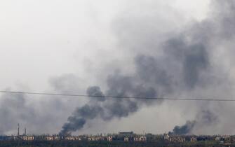 This photograph taken on April 11, 2024, near the town of Chasiv Yar, in Donetsk region, shows smoke rising from fires after bombing. (Photo by Anatolii STEPANOV / AFP)