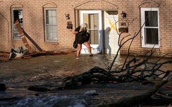 LITTLE ROCK, AR - MARCH 31: A woman evacuates from her home after a large tornado damaged hundreds of homes and buildings on March 31, 2023 in Little Rock, Arkansas. Tornados damaged hundreds of homes and buildings Friday afternoon across a large part of Central Arkansas. Governor Sarah Huckabee Sanders declared a state of emergency after the catastrophic storms that hit on Friday afternoon. According to local reports, the storms killed at least three people. (Photo by Benjamin Krain/Getty Images)