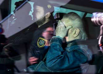TOPSHOT - Austrian Josef Fritzl, who imprisoned his daughter in a cellar for over 24 years and fathered seven children with her, is escorted  back to a prison after his hearing at the regional court in Krems an der Donau, Austria on January 25, 2024. The reginal court in Krems, some 80 kilometres (50 miles) northwest of Vienna, approved the application of Fritzl to be transferred out of the jail he is currently in for the mentally ill who pose a high degree of danger, to a regular prison. Fritzl, now 88, was sentenced to life in prison in 2009 for the murder by neglect of a new-born baby he fathered with his daughter Elisabeth while holding her in the purpose-built basement of his house. (Photo by Joe Klamar / AFP) (Photo by JOE KLAMAR/AFP via Getty Images)