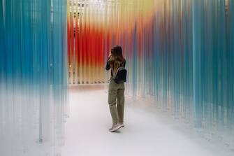 MILAN, ITALY - APRIL 15: A young woman uses her phone while visiting the installation "Straordinaria" by Elica / we+ during the Milan Design Week 2024 at Palazzo Litta on April 15, 2024 in Milan, Italy. Every year, the Salone Internazionale del Mobile and Fuorisalone define the Milan Design Week, the worldâ  s largest annual furniture and design event. Centered on principles of circular economy, reuse, and sustainable practices and materials, the Fuorisaloneâ  s 24 theme:Â â  Materia Naturaâ  , seeks to foster a culture of mindful design. (Photo by Emanuele Cremaschi/Getty Images)