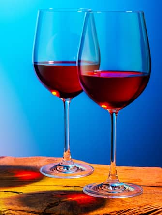 Two glasses of red wine. Intimate atmosphere. Romance concept