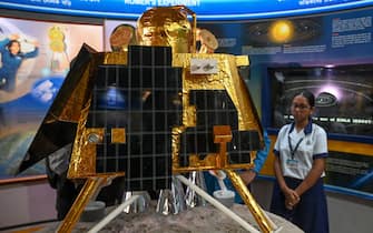 School students look at a model of Chandrayaan-3's Lander Module (LM) named as Vikram, at a technical museum in Kolkata on August 23, 2023. India's bid to become the first nation to land a spacecraft on the Moon's south pole neared its conclusion on August 23, the latest lunar push that has drawn in the world's top powers and new players. (Photo by DIBYANGSHU SARKAR / AFP) (Photo by DIBYANGSHU SARKAR/AFP via Getty Images)