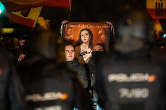 MADRID, SPAIN - 2023/11/09: A demonstrator hods a picture of the Immaculate Conception during a protest in front of socialist party PSOE headquarters in Ferraz street for the seventh consecutive day of protests following the recent agreement between PSOE and Junts party, which unfolded today in Brussels. Thousands responded to a call by far right groups to protest the approval of an amnesty for Catalan separatist leaders which is included in the agreement and guarantees the investiture of the socialist candidate Pedro Sanchez. (Photo by Marcos del Mazo/LightRocket via Getty Images)