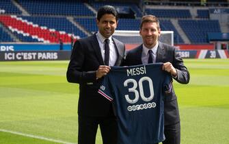 Paris Saint-Germain's Qatari President Nasser Al-Khelaifi poses along side Argentinian football player Lionel Messi as he holds-up his number 30 shirt while standing on the pitch during a press conference at the French football club Paris Saint-Germain's (PSG) Parc des Princes stadium in Paris on August 11, 2021. The 34-year-old superstar signed a two-year deal with PSG on August 10, 2021, with the option of an additional year, he will wear the number 30 in Paris, the number he had when he began his professional career at Spain's Barca football club. Photo by Laurent Zabulon/ABACAPRESS.COM