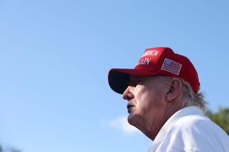 BEDMINSTER, NEW JERSEY - AUGUST 13: Former President Donald Trump signs autographs hits his shot from the 16th tee during day three of the LIV Golf Invitational - Bedminster at Trump National Golf Club on August 13, 2023 in Bedminster, New Jersey. (Photo by Mike Stobe/Getty Images)