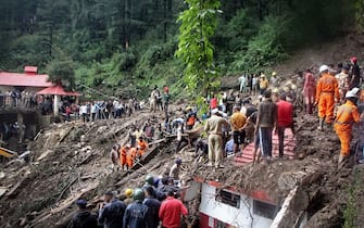 National Disaster Response Force (NDRF) personnel search for victims at the site of a landslide after a temple collapsed due to heavy rains in Shimla on August 14, 2023. At least 24 people were killed, nine of them in a temple collapse, and dozens more were feared missing after intense rains caused floods and landslides in India, officials said aUGUST 14. (Photo by AFP) (Photo by -/AFP via Getty Images)
