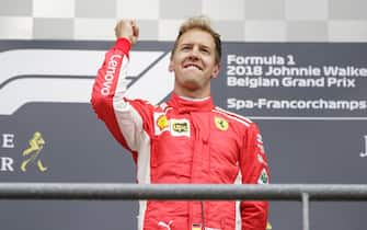 SPA-FRANCORCHAMPS, BELGIUM - AUGUST 26: Sebastian Vettel, Ferrari, 1st position, celebrates on the podium during the Belgian GP at Spa-Francorchamps on August 26, 2018 in Spa-Francorchamps, Belgium. (Photo by Zak Mauger / LAT Images)