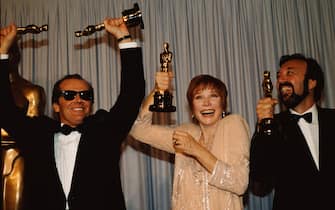 LOS ANGELES, CA - USA. Jack Nicholson, Shirley McLaine & James L. Brooks at the 56th Academy Awards in 1984. Terms of Endearment won awards for acting, directing and screen writing. All three seen here holding their awards triumphantly.