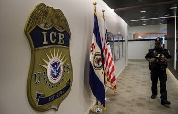 WASHINGTON, DC - MAY 11: A law enforcement officer walks past ICE logo ahead of a press conference on Thursday, May 11, 2017, at the U.S. Immigration and Customs Enforcement  headquarters in Washington, DC. (Photo by Salwan Georges/The Washington Post via Getty Images)