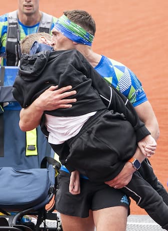Kevin Sinfield kisses Rob Burrow as he carries him across the finish line of the 2023 Rob Burrow Leeds Marathon which started and finished at Headingley Stadium, Leeds. Picture date: Sunday May 14, 2023. (Photo by Danny Lawson/PA Images via Getty Images)
