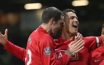 Manchester United's Cristiano Ronaldo (c) celebrates scoring his second goal with team mates John O'Shea (l) and Luis Nani (r)